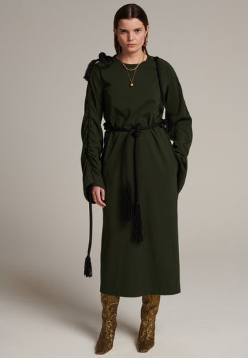 FRENKEN oversized jersey dress with long wide sleeves crafted in soft light dark green cotton, detailed with this season's cord theme. The chunky cords are displayed along the sleeves and can be pulled out to create shape and to shorten the sleeves, making the most of this statement style. The cord ends are hand frayed, a refined couture detail.