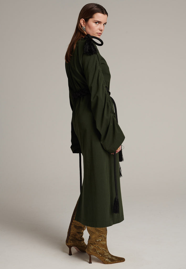 FRENKEN oversized jersey dress with long wide sleeves crafted in soft light dark green cotton, detailed with this season's cord theme. The chunky cords are displayed along the sleeves and can be pulled out to create shape and to shorten the sleeves, making the most of this statement style. The cord ends are hand frayed, a refined couture detail.