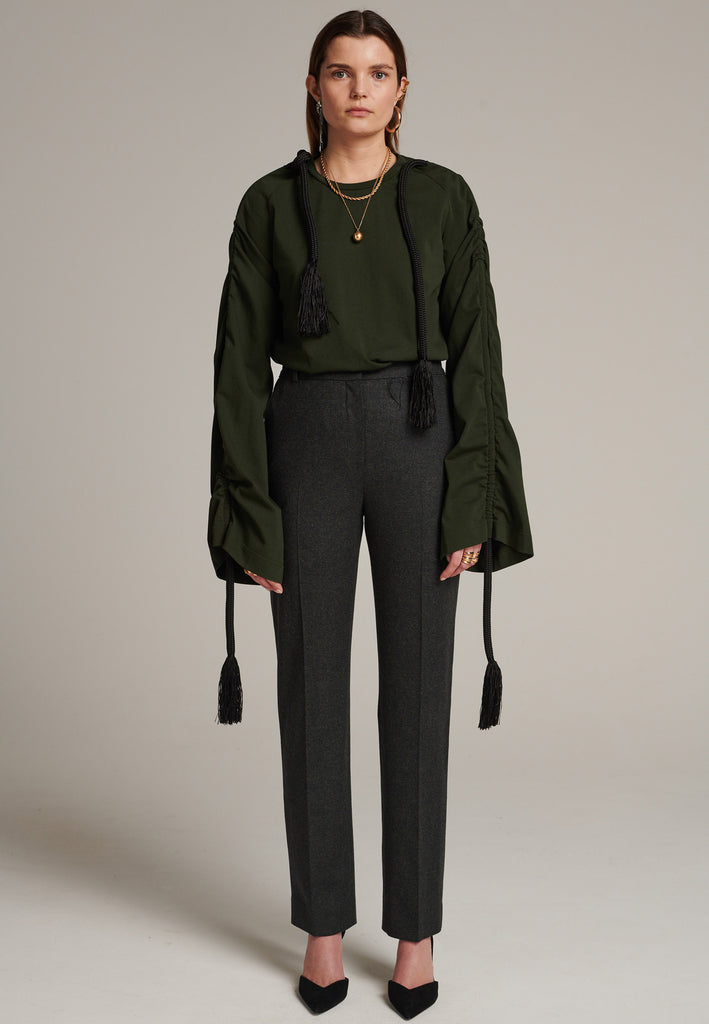 Oversized jersey with long wide sleeves crafted in soft dark green cotton, detailed with this season's cord theme. The chunky cords are displayed along the sleeves and can be pulled out to create shape and shorten the sleeves. The cord ends are hand frayed, a refined couture detail.