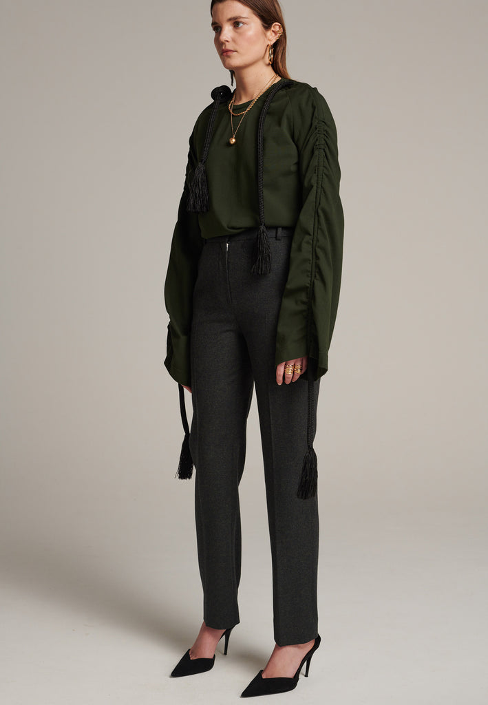 Oversized jersey with long wide sleeves crafted in soft dark green cotton, detailed with this season's cord theme. The chunky cords are displayed along the sleeves and can be pulled out to create shape and shorten the sleeves. The cord ends are hand frayed, a refined couture detail.