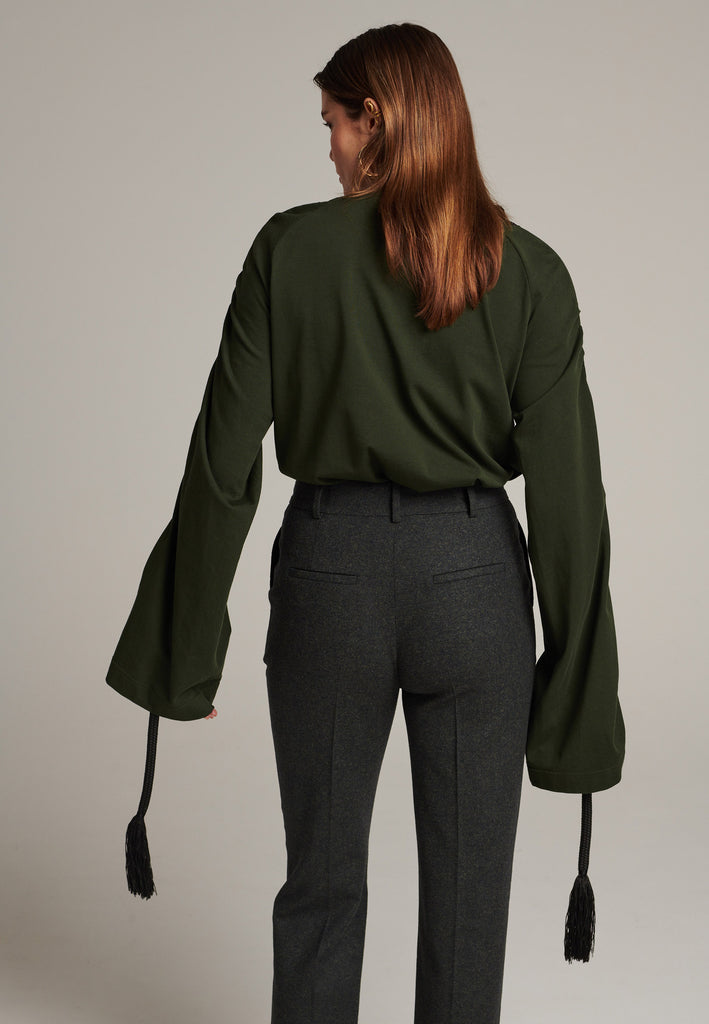 Oversized jersey with long wide sleeves crafted in soft dark green cotton, detailed with this season's cord theme. The chunky cords are displayed along the sleeves and can be pulled out to create shape and shorten the sleeves. The cord ends are hand frayed, a refined couture detail.