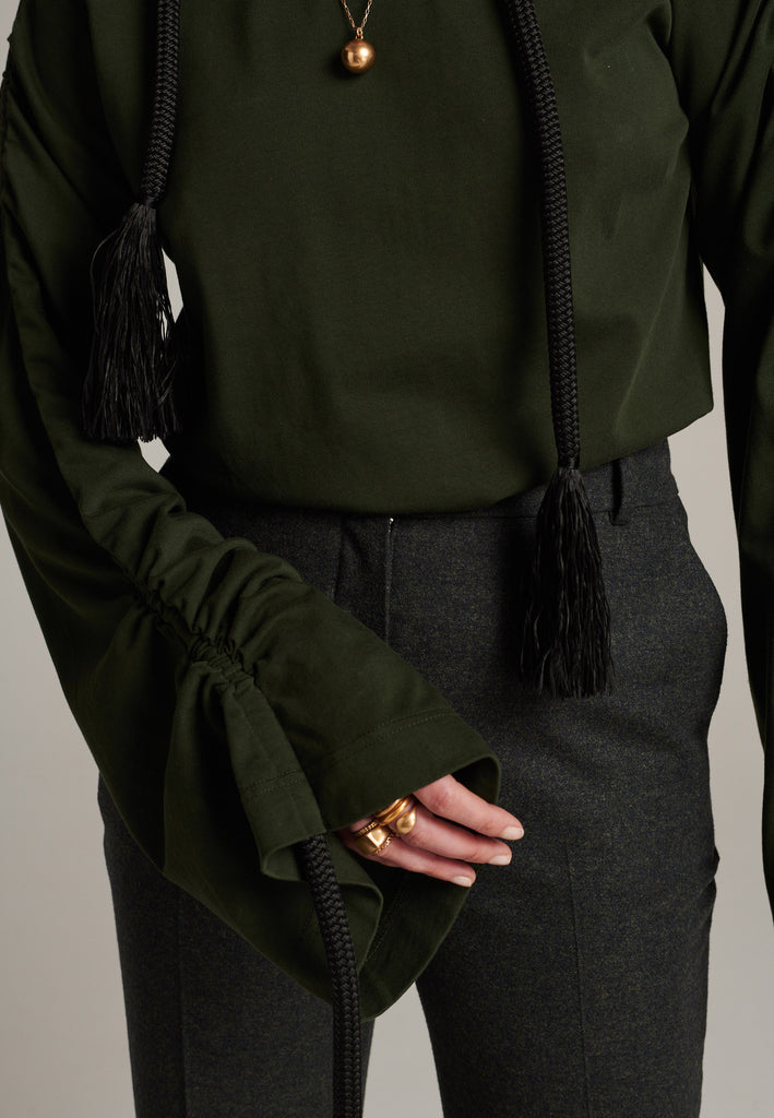 Oversized jersey with long wide sleeves crafted in soft dark green cotton, detailed with this season's cord theme. The chunky cords are displayed along the sleeves and can be pulled out to create shape and shorten the sleeves. The cord ends are hand frayed, a refined couture detail.