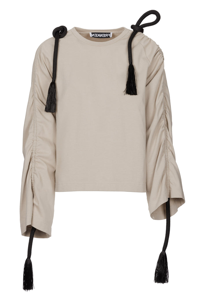 Oversized jersey with long wide sleeves crafted in soft light camel cotton, detailed with this season's cord theme. The chunky cords are displayed along the sleeves and can be pulled out to create shape and shorten the sleeves. The cord ends are hand frayed, a refined couture detail.