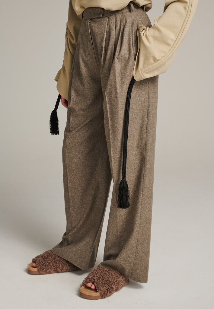 Pleated high-rise pants with wide-leg fitting made of a soft wool blend flannel in stone. It's designed to move beautifully as you walk. Back welt pockets. Menswear-inspired tailored waistband. One of the chicest ways to wear relaxed tailoring.