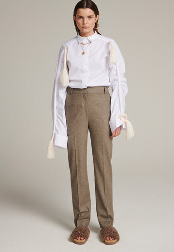 Mid-rise straight-leg pants that create a sleek silhouette. Made from a soft wool blend in stone with back welt pockets. Menswear-inspired tailored waistband. Pressed front pleat that elongates the leg for a sophisticated fitting.