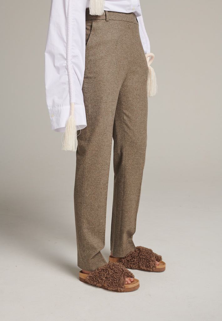 Mid-rise straight-leg pants that create a sleek silhouette. Made from a soft wool blend in stone with back welt pockets. Menswear-inspired tailored waistband. Pressed front pleat that elongates the leg for a sophisticated fitting.