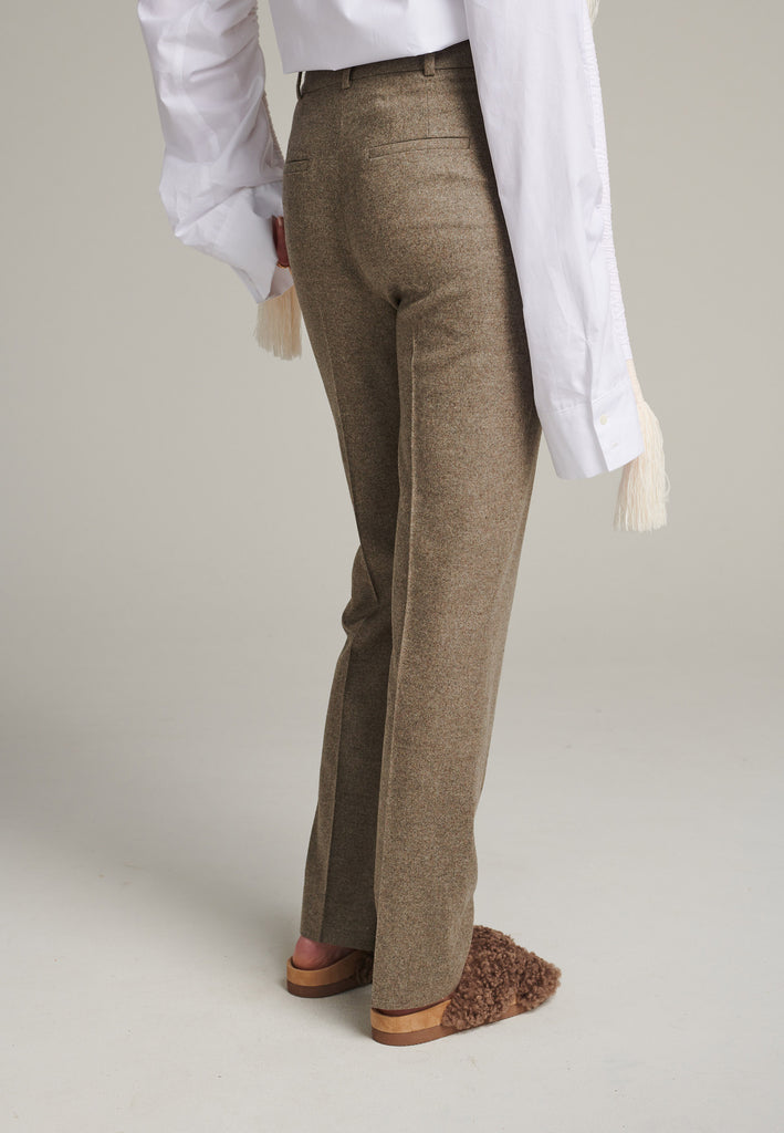 Mid-rise straight-leg pants that create a sleek silhouette. Made from a soft wool blend in stone with back welt pockets. Menswear-inspired tailored waistband. Pressed front pleat that elongates the leg for a sophisticated fitting.