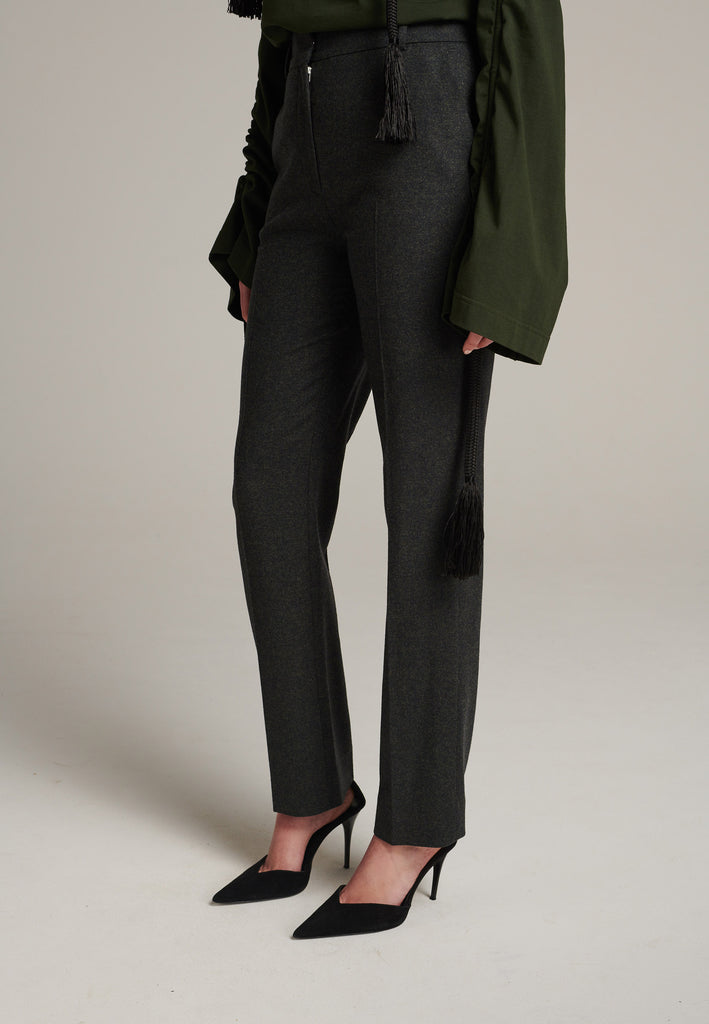 Mid-rise straight-leg pants that create a sleek silhouette. Made from a soft wool blend in back green with back welt pockets. Menswear-inspired tailored waistband. Pressed front pleat that elongates the leg for a sophisticated fitting.