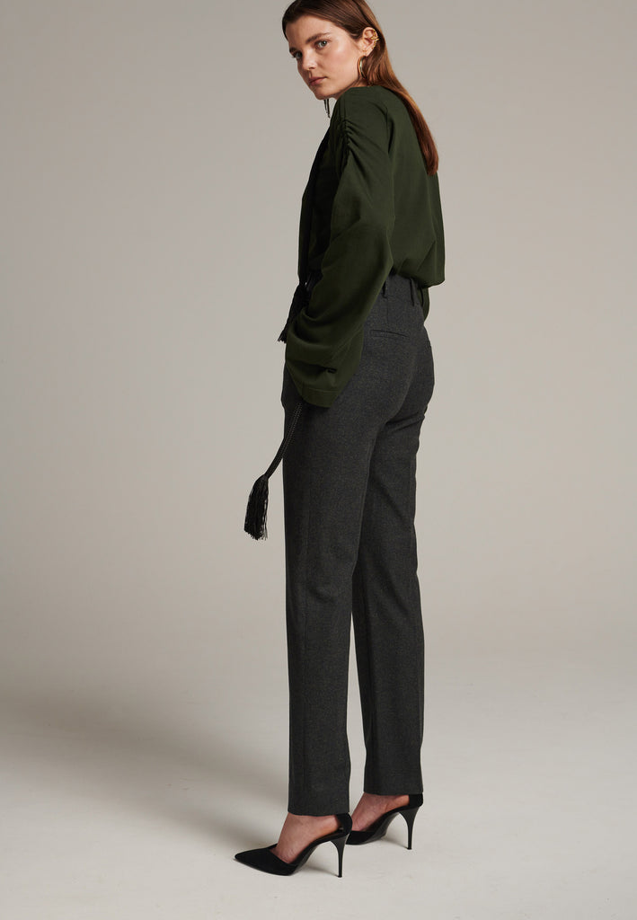 Mid-rise straight-leg pants that create a sleek silhouette. Made from a soft wool blend in back green with back welt pockets. Menswear-inspired tailored waistband. Pressed front pleat that elongates the leg for a sophisticated fitting.