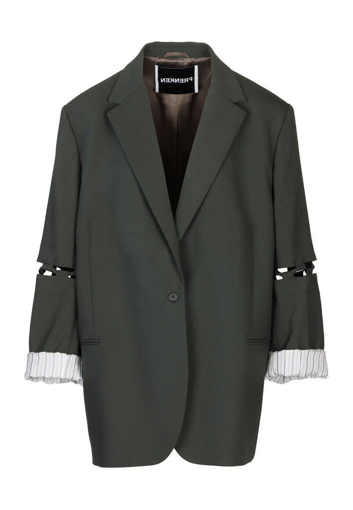 Menswear-inspired smoking blazer in dark green with horn buttons and shoulder pads, emphasizing the oversized fitting. The exaggerated long sleeves can be rolled up to reveal a striped lining. The blazer features a cut-out section around the elbow, making a two-piece sleeve held together by a finely laced string. Can be worn elegantly open, loose or tied together.