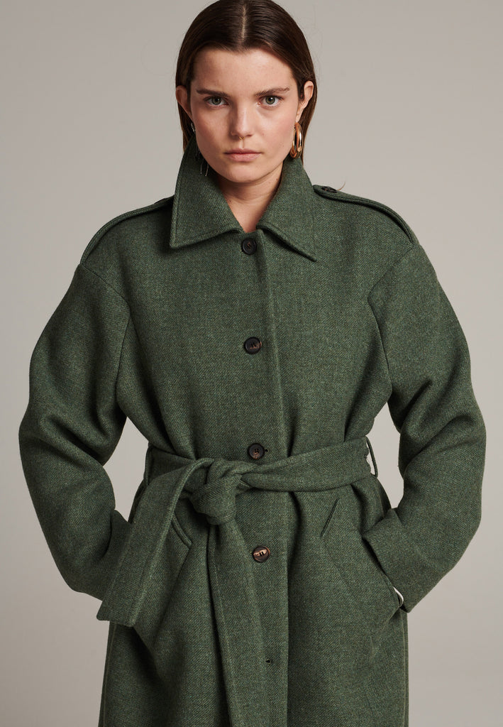 Oversized relaxed-fit coat in green melange cut from a recycled soft wool blend, fully lined with satin. It comes with a coordinating belt to temper the loose fit and to cinch to the waistline.