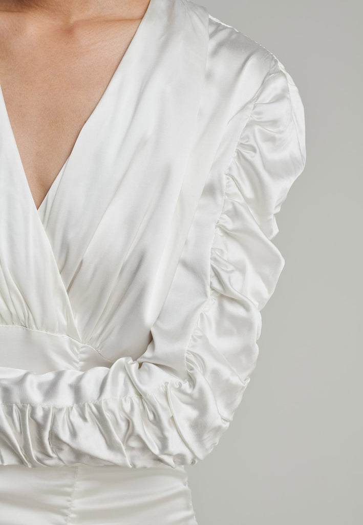 Satin midi dress in off-white. Features a v-neck, wrinkled-style hip and arms, and leg opening. True to size.
