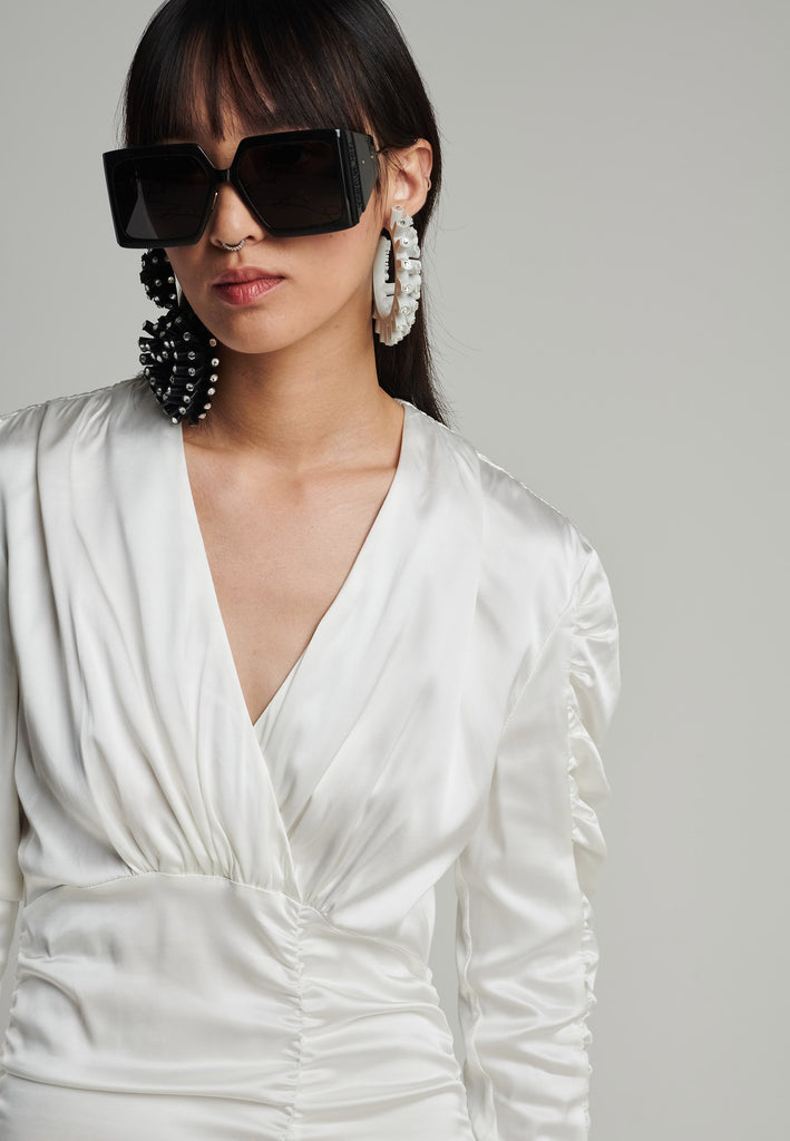 Satin midi dress in off-white. Features a v-neck, wrinkled-style hip and arms, and leg opening. True to size.