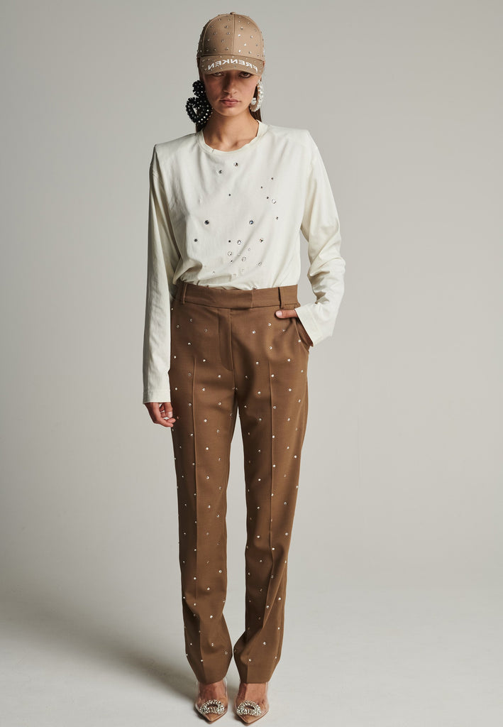 Cotton long-sleeved top in off-white. Features sprinkled Swarovski diamonds, and shoulder pads. True to size.
