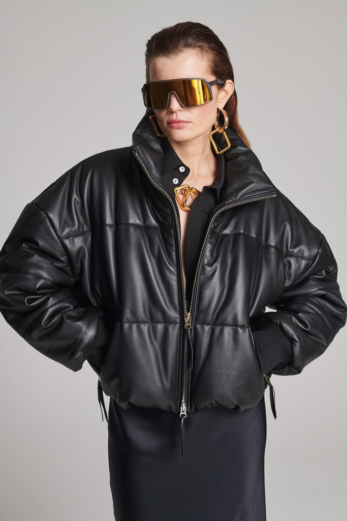Wide-shouldered leather fully lined puffer coat. Features elasticated cuffs, zip fastening and pockets. Fits oversized.
