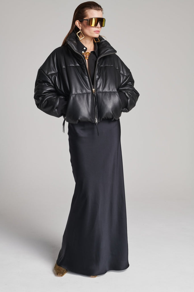 Wide-shouldered leather fully lined puffer coat. Features elasticated cuffs, zip fastening and pockets. Fits oversized.
