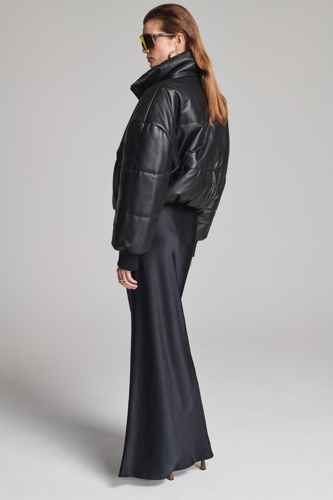 Wide-shouldered leather fully lined puffer coat. Features elasticated cuffs, zip fastening and pockets. Fits oversized.
