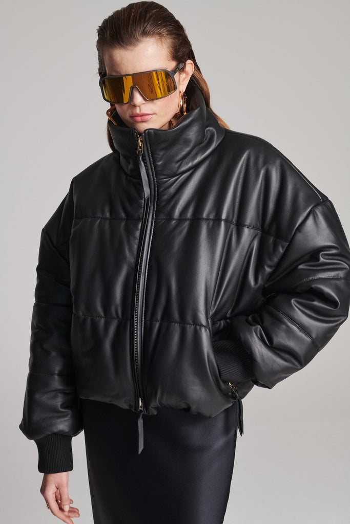 Wide-shouldered leather fully lined puffer coat. Features elasticated cuffs, zip fastening and pockets. Fits oversized.
