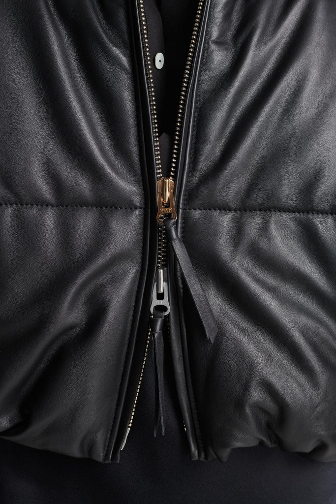 Wide-shouldered leather fully lined puffer coat. Features elasticated cuffs, zip fastening and pockets. Fits oversized.