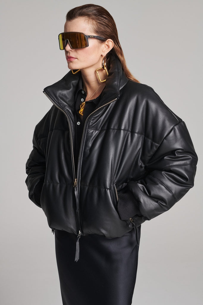 Wide-shouldered leather fully lined puffer coat. Features elasticated cuffs, zip fastening and pockets. Fits oversized.