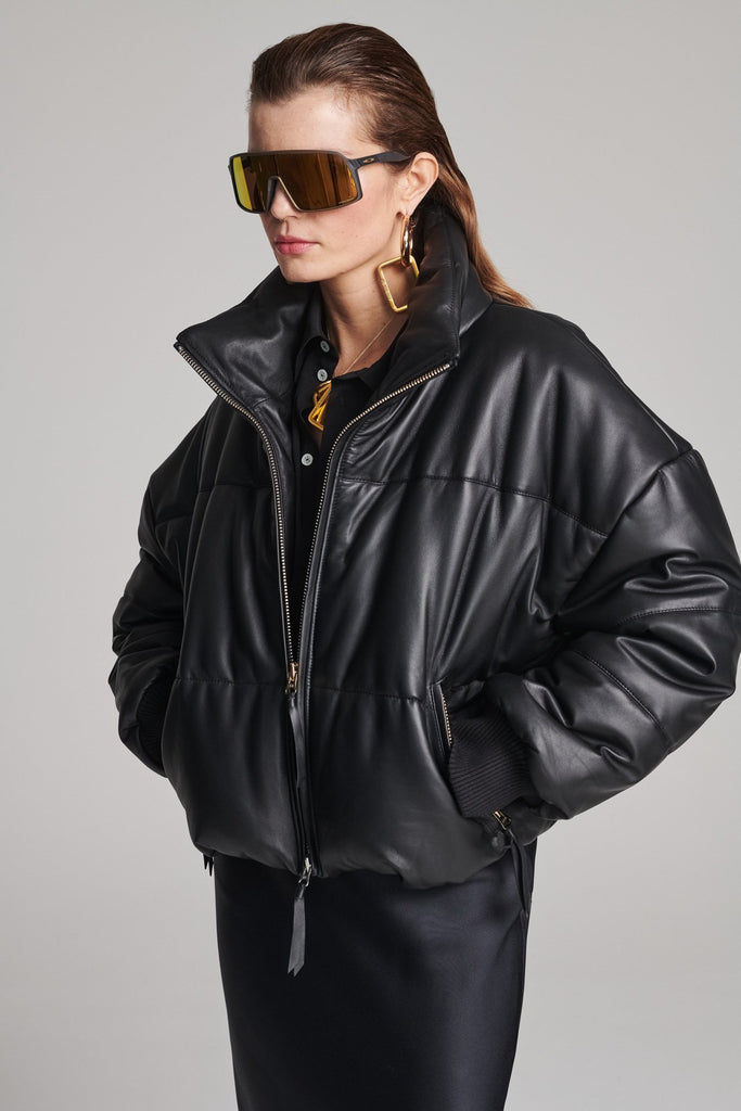 Wide-shouldered leather fully lined puffer coat. Features elasticated cuffs, zip fastening and pockets. Fits oversized.