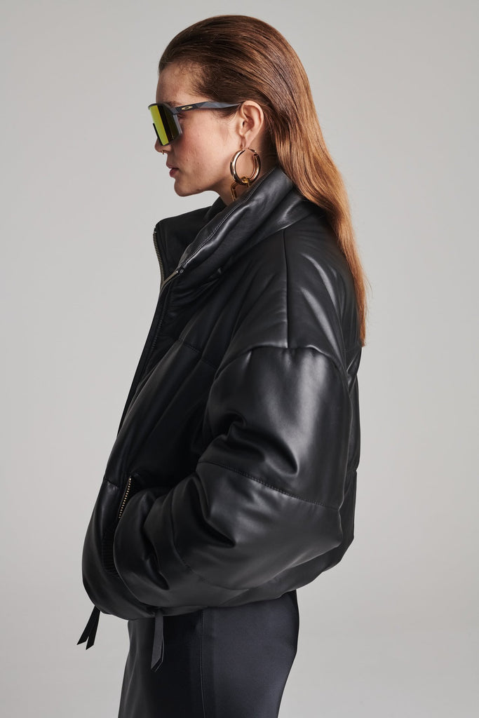 Wide-shouldered leather fully lined puffer coat. Features elasticated cuffs, zip fastening and pockets. Fits oversized.