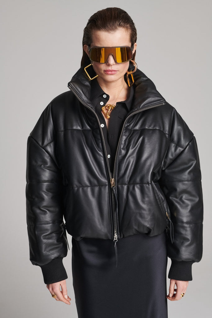 Wide-shouldered leather fully lined puffer coat. Features elasticated cuffs, zip fastening and pockets. Fits oversized.