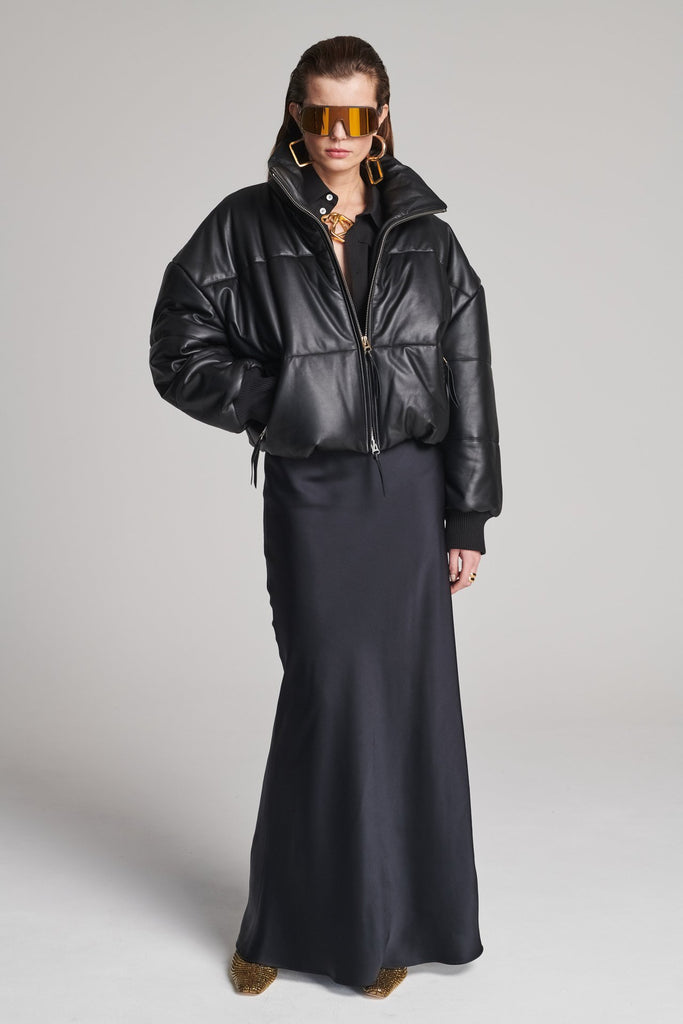 Wide-shouldered leather fully lined puffer coat. Features elasticated cuffs, zip fastening and pockets. Fits oversized.