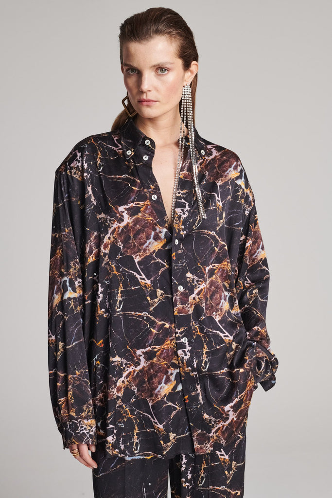 Wide-shouldered shirt with a shiny stretch brown digital marble print. Spiced-up with sprinkled dazzling Swarovski diamonds. Features a button fly-front. Fits oversize.