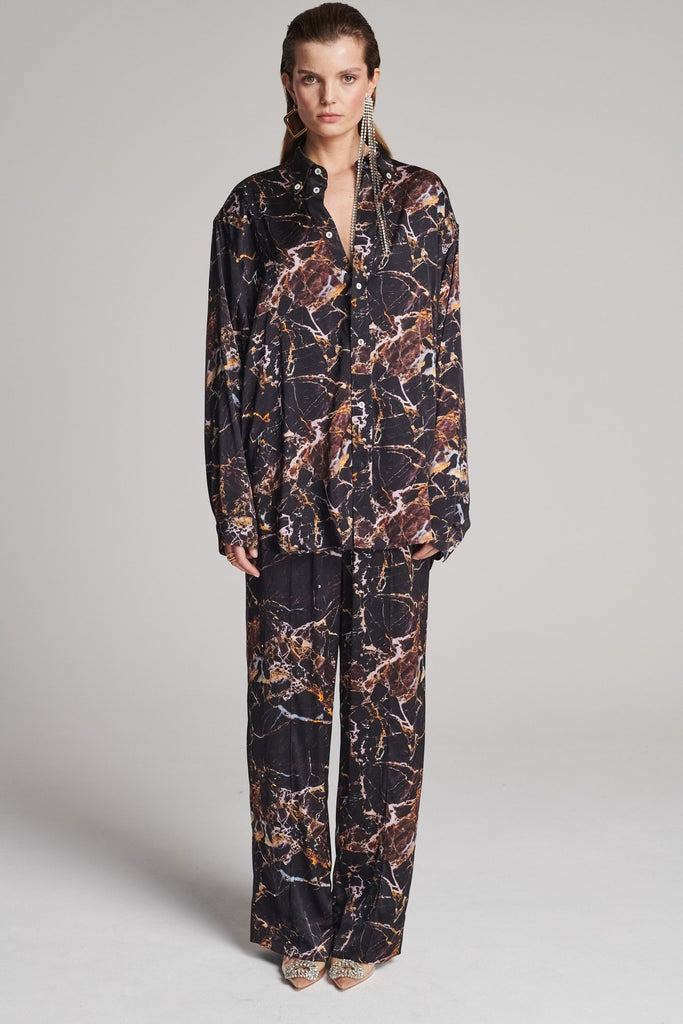 Wide-shouldered shirt with a shiny stretch brown digital marble print. Spiced-up with sprinkled dazzling Swarovski diamonds. Features a button fly-front. Fits oversize.