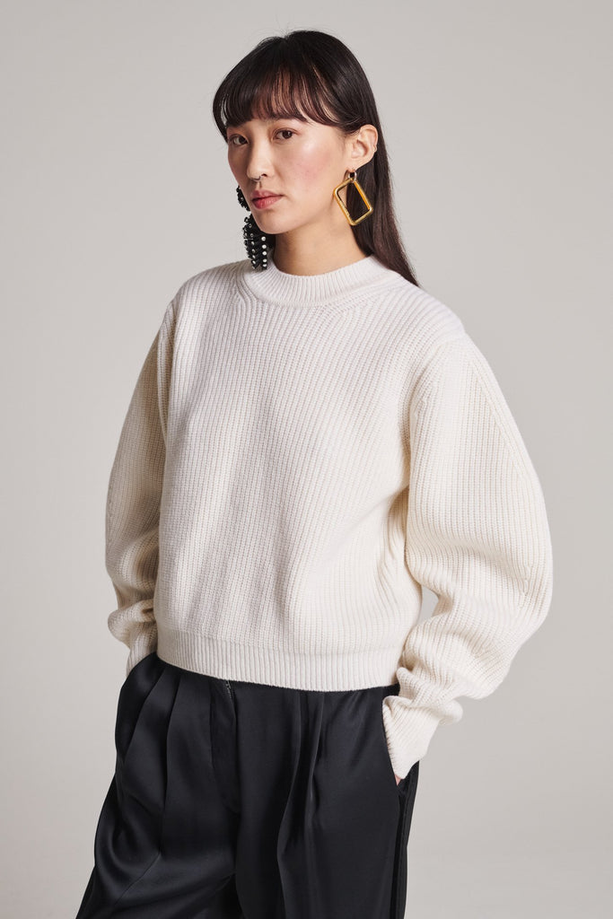 Knitted jumper in merino wool. Features a round neck, batwing sleeves, elasticated neck and cuffs and a stretchy effect for complete comfort. Fits oversized.