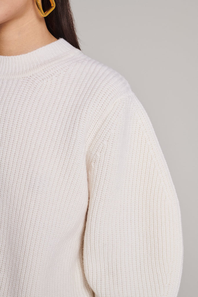 Knitted jumper in merino wool. Features a round neck, batwing sleeves, elasticated neck and cuffs and a stretchy effect for complete comfort. Fits oversized.