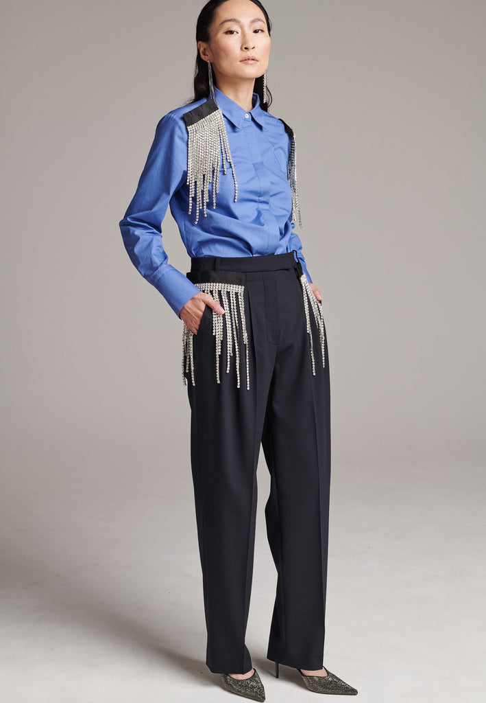 Long mild wide-leg trousers enhanced with waist pleats. Designed with detachable crystals, a true couture detail to play with. Crystals fall from a grosgrain tape that links to the trousers by fabric-covered buttons. Made from soft summer wool with a hint of elastane for maximum comfort. Detailed with side and welt pockets.