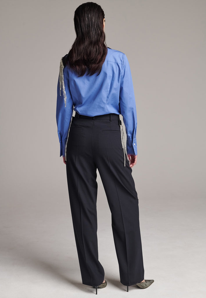 Long mild wide-leg trousers enhanced with waist pleats. Designed with detachable crystals, a true couture detail to play with. Crystals fall from a grosgrain tape that links to the trousers by fabric-covered buttons. Made from soft summer wool with a hint of elastane for maximum comfort. Detailed with side and welt pockets.