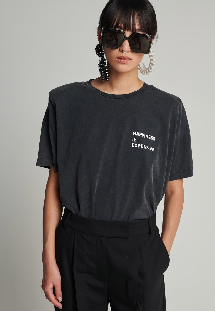 Cotton t-shirt in black. Features a crack-print with the phrase "Happiness is expensive". True to size.