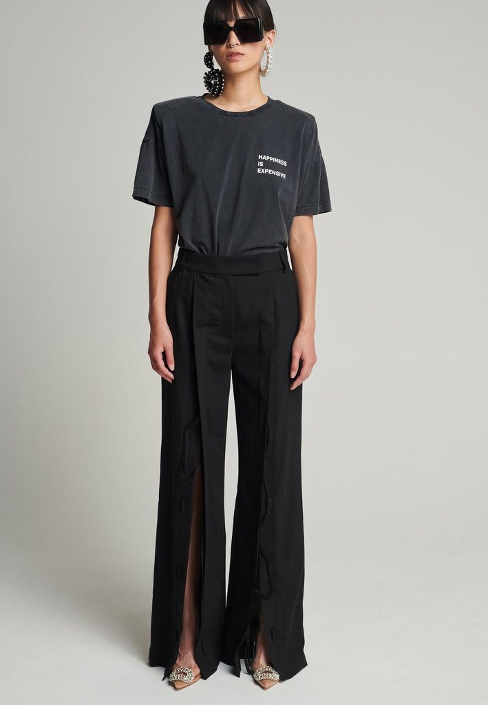 Cotton t-shirt in black. Features a crack-print with the phrase "Happiness is expensive". True to size.
