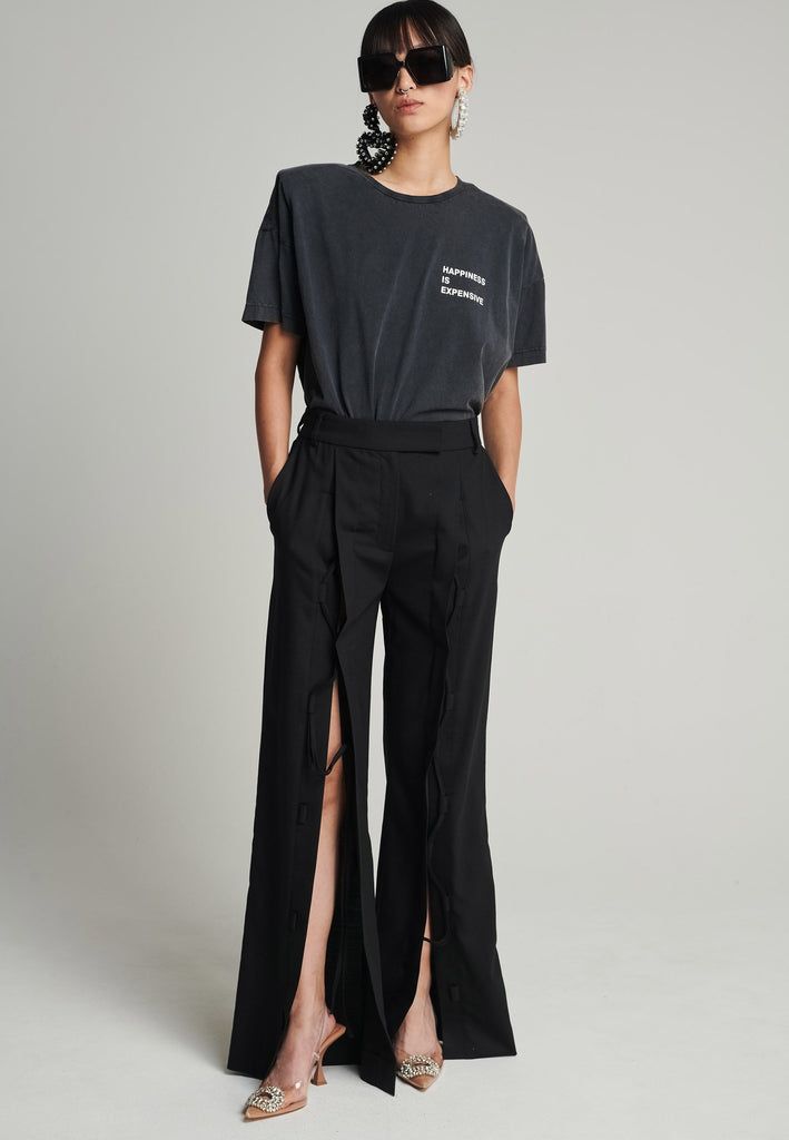 Cotton t-shirt in black. Features a crack-print with the phrase "Happiness is expensive". True to size.