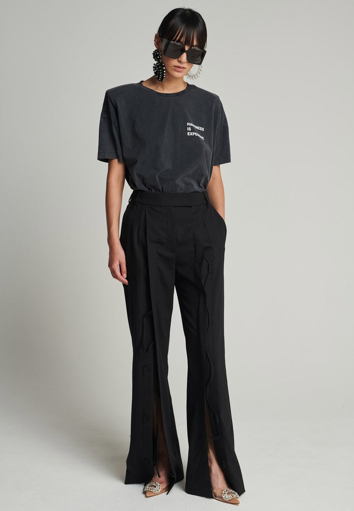 Cotton t-shirt in black. Features a crack-print with the phrase "Happiness is expensive". True to size.