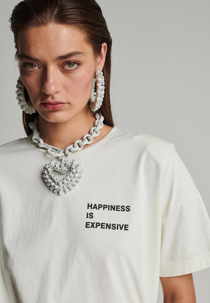 Cotton t-shirt in off-white. Features a crack-print with the phrase "Happiness is expensive". True to size.