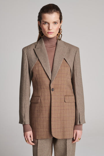 Shoulder-padded fitted blazer. Cut from the finest checked suiting wool blend. Features two checked fabrics miraculosly combined in one design. Detailed with a check double layer at the front top panel and back. True to size.