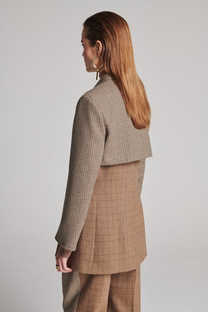 Shoulder-padded fitted blazer. Cut from the finest checked suiting wool blend. Features two checked fabrics miraculosly combined in one design. Detailed with a check double layer at the front top panel and back. True to size.