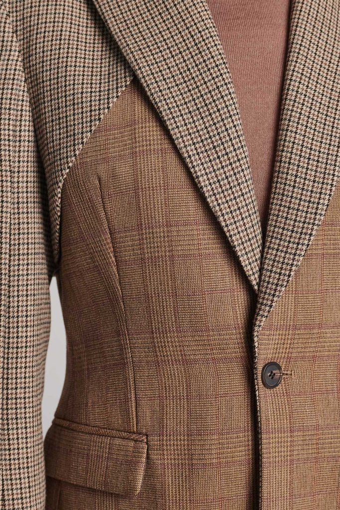 Shoulder-padded fitted blazer. Cut from the finest checked suiting wool blend. Features two checked fabrics miraculosly combined in one design. Detailed with a check double layer at the front top panel and back. True to size.