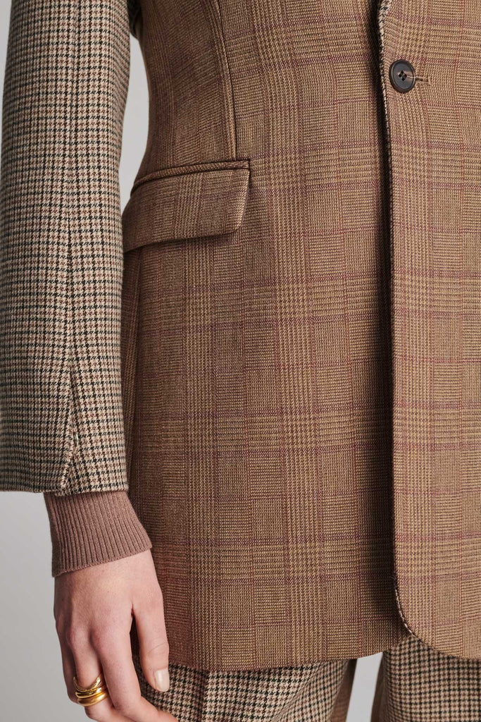 Shoulder-padded fitted blazer. Cut from the finest checked suiting wool blend. Features two checked fabrics miraculosly combined in one design. Detailed with a check double layer at the front top panel and back. True to size.