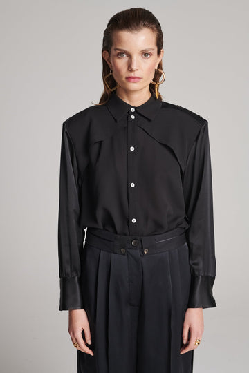 Shoulder-padded silk shirt. Features a double layer at the front top panel and back. Detailed with a button fly-front and adjustable cuffs. True to size.