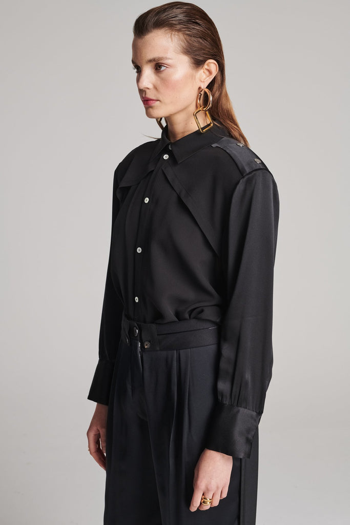 Shoulder-padded silk shirt. Features a double layer at the front top panel and back. Detailed with a button fly-front and adjustable cuffs. True to size.