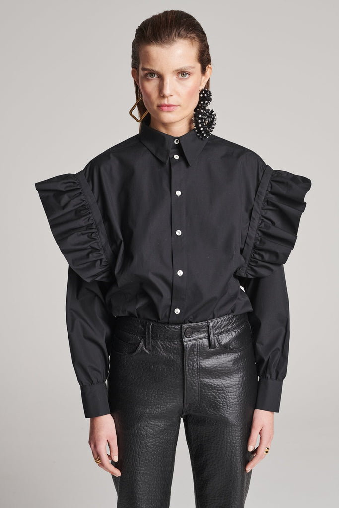 Wide-shouldered shirt with button fly-front. Features a batwing armhole with a detachable shoulder ruffle. Detailed with gold and silver press buttons, use them to separate the shirt's arms. Fits oversize.