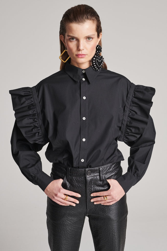 Wide-shouldered shirt with button fly-front. Features a batwing armhole with a detachable shoulder ruffle. Detailed with gold and silver press buttons, use them to separate the shirt's arms. Fits oversize.