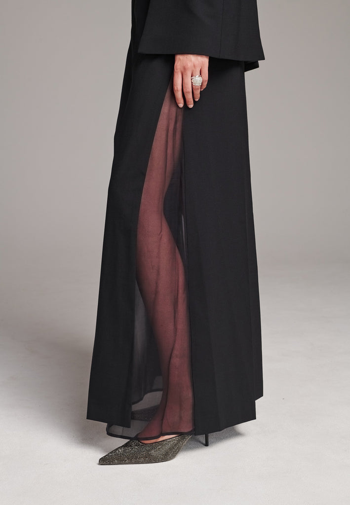 FOLLOW, a deconstructed chino turned into a double-layered skirt. Featuring prominent front and back slits which create effortless movement within every step. The side slits reveal the smooth silk georgette layer underneath making it the perfect day-to-night statement piece.