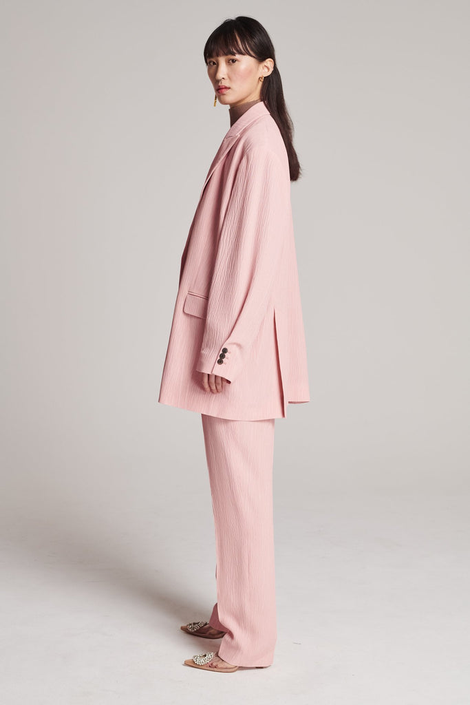 Wide-shouldered blazer, fluid and loose for complete comfort. Features shoulder pads and plisse details. Fits oversized.