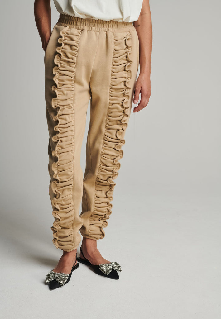 Ruffled sweatpants in camel. Features an crinkled effect, and elastic waistband and ankle cuffs. True to size.